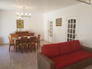 a living room with a red couch and a table at Manta Azul in Manta Rota