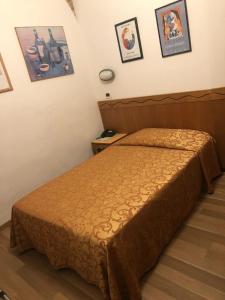 a bedroom with a bed in a room at Hotel Nuova Italia in Florence +43 photos