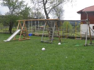 an outdoor playground with a slide and swings at Pripetzite Hotel in Godlevo
