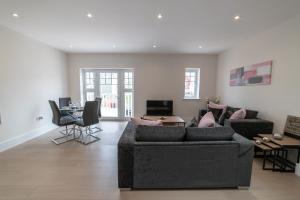 a living room with two couches and a table at Reading Green Park Village Serviced Apartments in Reading