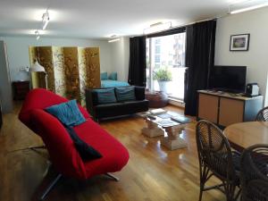 a living room with a red couch and a table at Vila Real Loft 360º in Vila Real