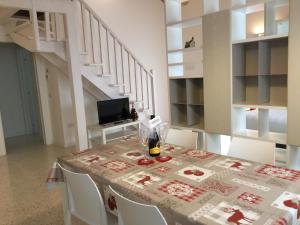 a dining room with a table and white stairs at Quirinus Venetia Properties in Mestre