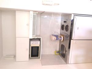 a small kitchen with a sink and a refrigerator at Résid'Artel Cadarache - ITER in Saint-Paul-lez-Durance