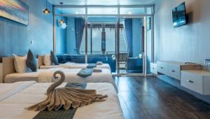a hotel room with two beds with a swan on them at Sara Resort in Koh Rong Sanloem