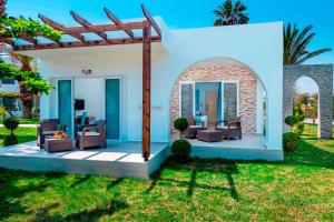 a home with an arbor and a patio at Smy Kos Beach & Splash in Mastihari