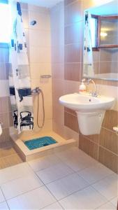 a bathroom with a sink and a shower at Summer View in Skala