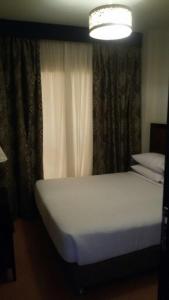 Кровать или кровати в номере Porto Golf Marina Apartments By Amer-Group