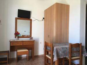 una sala da pranzo con tavolo e specchio di Eugenia travasarou sea view appartments a Diakofti