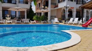 a swimming pool with a slide in a hotel at Brilliant Aparthotel in Sozopol