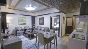 a living room with a couch and a table at Niyaf Serviced Apartments in Khamis Mushayt