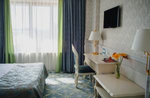 Postel nebo postele na pokoji v ubytování Olympic Hotel