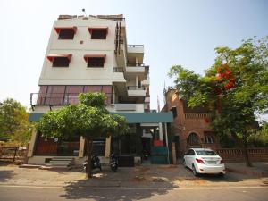 a white car parked in front of a building at Hotel Ajit Mansion in Jodhpur
