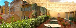 a patio area with a table, chairs, and a patio umbrella at Hotel Berchielli in Florence