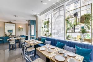 a restaurant with tables and chairs and a window at Passy Eiffel in Paris