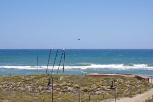 a view of the ocean from a beach with lights at Apartaments Beach & Golf Resort in Pals
