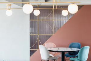 a meeting room with chairs and a table and lights at Evripides Hotel in Athens