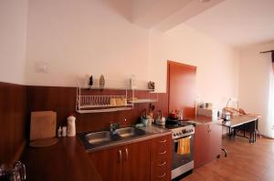 a kitchen with a sink and a stove at Sunset in Karwia