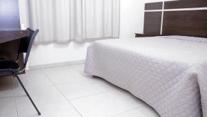 Säng eller sängar i ett rum på Hotel Sul Três Lagoas
