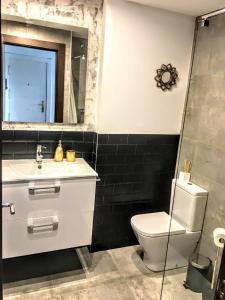 La salle de bains est pourvue de toilettes, d'un lavabo et d'un miroir. dans l'établissement Apartamento Gaztainondoak, à Lanciego