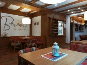 a dining room with a table and chairs and a restaurant at Hotel Miramonti in Pinzolo