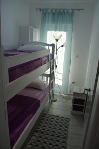 two bunk beds in a room with a window at Apartmani Juresko Mrljane in Mrljane
