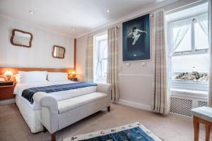 a bedroom with a bed and a window at The Waterfront in Portpatrick