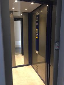 a glass door with a baseball bat on the wall at Cozy Apartment Mati Lago Maggiore in Verbania