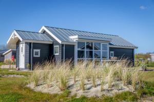 ein Haus mit Solardach am Strand in der Unterkunft Duinpark Westerschouwen in Burgh Haamstede