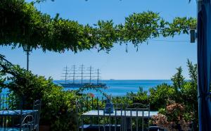 a view of the ocean from a patio at Hotel Palladio in Giardini Naxos