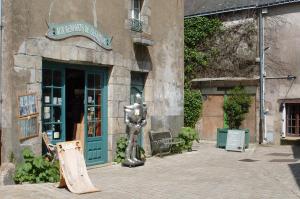 a building with a sign in front of a store at lesChenes in Saint-Dolay