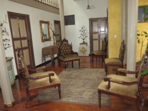 a living room with chairs and a rug at Hotel Casa San Rafael in Cuenca