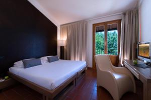Een bed of bedden in een kamer bij CDH Hotel Radda