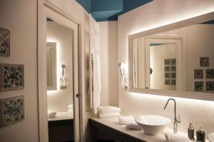 a bathroom with a sink and a mirror at Hotel Palladio in Giardini Naxos