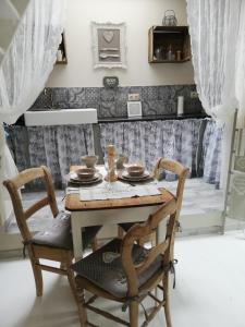 a dining room with a table and two chairs at La petite douane in Massembre