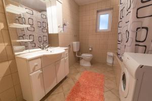 a bathroom with a sink toilet and a washing machine at Stella Maris Accommodation in Klenovica +85 photos