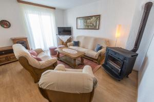 a living room with couches and a wood stove at Stella Maris Accommodation in Klenovica