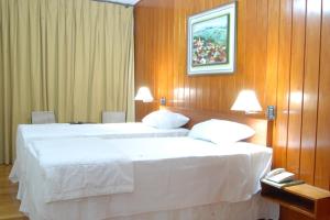 Un pat sau paturi într-o cameră la Hotel Tijuco Turismo
