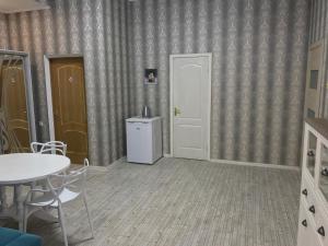 a room with a table and a white door at Happy Cat in Odesa