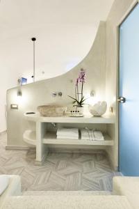 a white bathroom with a sink and a toilet at Margo Houses in Vóthon