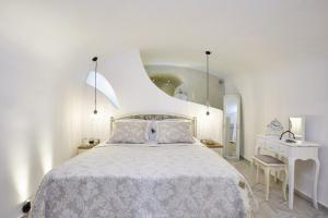 a bedroom with a large bed with a white bedspread at Margo Houses in Vóthon +52 photos