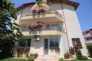 a building with flower boxes on the balconies at Guest House Kiwi in Golden Sands