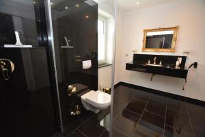 ein Badezimmer mit Toilette, Waschbecken und Spiegel in der Unterkunft Ferienhaus Merzijana in Büsum + 37 Fotos