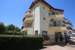 a tall building with a fence in front of it at Guest House Kiwi in Golden Sands +46 photos