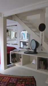 a room with a bed and a desk with a mirror at stipologic Duplex in Paris