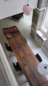 a large wooden table in a living room with chairs at stipologic Duplex in Paris