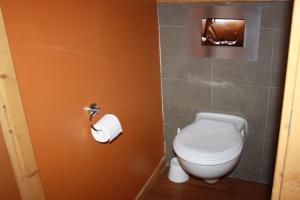 a bathroom with a toilet and a roll of toilet paper at L'ours blanc in LʼHuez