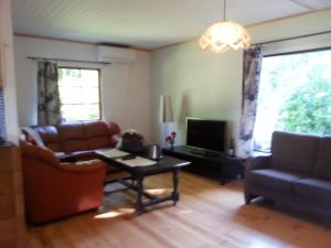 a living room with a couch and a table at Björboholm in Gråbo