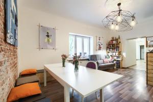 a living room with a white table and a couch at Lull Hostel in Warsaw