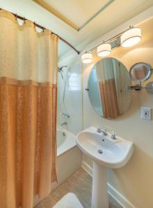 a bathroom with a sink and a shower curtain at Henderson Park Inn in Destin