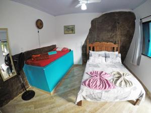 Postel nebo postele na pokoji v ubytování Suítes Cantinho da Pedra
